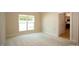 Bedroom with carpet floors and large windows offering views of the surrounding landscape at 1503 Orchard Villas Ave, Apex, NC 27502