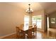 Bright dining room featuring hardwood floors, natural light from the windows, and a modern light fixture at 1503 Orchard Villas Ave, Apex, NC 27502