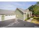 Exterior view of the home highlighting the attached two-car garage and well-kept landscaping at 1503 Orchard Villas Ave, Apex, NC 27502