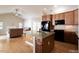 Open-concept kitchen with a breakfast bar island and views of the dining and living areas at 1503 Orchard Villas Ave, Apex, NC 27502