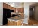 Kitchen with dark appliances, granite countertops, wooden cabinets and breakfast bar at 1503 Orchard Villas Ave, Apex, NC 27502