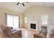 Bright living room featuring a fireplace, hardwood floors, and sliding door to the outdoor space at 1503 Orchard Villas Ave, Apex, NC 27502
