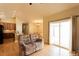 Spacious living room with hardwood floors and a view of the open kitchen and dining area at 1503 Orchard Villas Ave, Apex, NC 27502