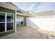 Private patio area featuring a white fence, concrete flooring, and views of the backyard at 1503 Orchard Villas Ave, Apex, NC 27502