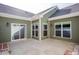 An inviting patio featuring a sliding glass door and large windows, perfect for outdoor living at 1503 Orchard Villas Ave, Apex, NC 27502