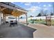 A spacious backyard boasts a covered patio, seating, playground, fire pit and lush green lawn, creating a perfect outdoor space at 151 Kutter Dr, Elon, NC 27244