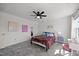 Charming bedroom featuring modern ceiling fan, plush bed with cute plushies, and a pristine white interior at 151 Kutter Dr, Elon, NC 27244