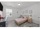 Bright bedroom featuring a twin bed, soft gray walls, and natural light from the window at 151 Kutter Dr, Elon, NC 27244