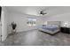 Spacious bedroom featuring a large window, updated flooring, modern lighting, and a comfortable bed at 151 Kutter Dr, Elon, NC 27244