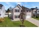 Charming two-story home with a well-manicured lawn, attached two-car garage and complementary landscaping at 151 Kutter Dr, Elon, NC 27244