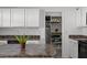 Well-organized pantry with shelves and storage space next to modern appliances at 151 Kutter Dr, Elon, NC 27244