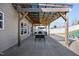 Spacious patio area with covered pergola, perfect for outdoor dining and entertaining with a seating area and concrete flooring at 151 Kutter Dr, Elon, NC 27244