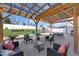 Beautiful outdoor patio area with pergola covering, play set, a lounge area and a well-maintained, landscaped yard at 151 Kutter Dr, Elon, NC 27244