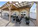 Inviting patio with a covered pergola, offering a shaded retreat with comfortable seating, plants and views of the fenced yard at 151 Kutter Dr, Elon, NC 27244