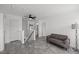 Upstairs area with gray flooring, a sofa, and doors leading to other rooms at 151 Kutter Dr, Elon, NC 27244