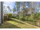 Backyard featuring a well-maintained lawn, a wooden deck, and privacy fencing at 1720 Highpoint St, Wake Forest, NC 27587