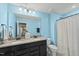 Bathroom featuring double vanity with granite countertop, blue walls, and a shower with curtain at 1720 Highpoint St, Wake Forest, NC 27587
