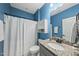 Stylish bathroom featuring modern fixtures, a granite countertop, and a classic shower curtain at 1720 Highpoint St, Wake Forest, NC 27587