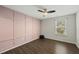 Unique bedroom with hardwood floors, panel accent wall, and ample natural light offer modern elegance at 1720 Highpoint St, Wake Forest, NC 27587