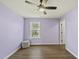 Airy bedroom with hardwood floors, ceiling fan, and a scenic window creates a peaceful retreat at 1720 Highpoint St, Wake Forest, NC 27587