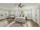A well-lit main bedroom features hardwood floors and large windows for plenty of natural light at 1720 Highpoint St, Wake Forest, NC 27587