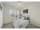 Cozy bedroom with natural light, carpet flooring, and a window that offers a pleasant view at 1720 Highpoint St, Wake Forest, NC 27587