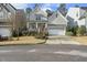 Charming two-story home features a welcoming front porch, well-manicured landscaping, and a two-car garage at 1720 Highpoint St, Wake Forest, NC 27587