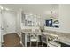 A home office space that looks into the kitchen and living room areas with hardwood floors at 1720 Highpoint St, Wake Forest, NC 27587