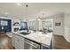 An open concept kitchen island featuring granite countertops that overlook the living room and fireplace at 1720 Highpoint St, Wake Forest, NC 27587