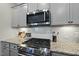 Granite countertops and herringbone backsplash compliment the stainless steel oven and microwave at 1720 Highpoint St, Wake Forest, NC 27587