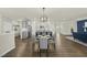 Bright open-concept kitchen featuring a large center island, stainless steel appliances, and stylish pendant lighting at 1720 Highpoint St, Wake Forest, NC 27587