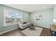 Cozy living room with a neutral sofa, area rug, and a window with natural light at 1720 Highpoint St, Wake Forest, NC 27587