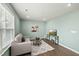Cozy living room featuring wood flooring, a comfortable sofa, and a flat-screen TV at 1720 Highpoint St, Wake Forest, NC 27587