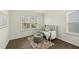 Comfortable sitting room with cozy chair, ottoman, and windows offering natural light and a scenic view at 1720 Highpoint St, Wake Forest, NC 27587