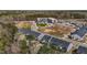 Aerial view of the townhome community with pond, commercial development and green space at 1805 Kauri Cliffs Dr, Fuquay Varina, NC 27526