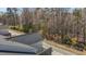Aerial view showcasing rooftop, wooded surroundings, and neighborhood layout at 1805 Kauri Cliffs Dr, Fuquay Varina, NC 27526
