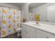 Bright bathroom featuring a single sink vanity with a disco themed shower curtain and modern finishes at 1805 Kauri Cliffs Dr, Fuquay Varina, NC 27526