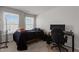 Bedroom with natural light features a bed, desk, and a gaming work space at 1805 Kauri Cliffs Dr, Fuquay Varina, NC 27526