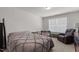 Spacious bedroom features a comfy bed, brown recliner and bright window at 1805 Kauri Cliffs Dr, Fuquay Varina, NC 27526