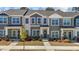 Charming townhouse featuring a well-maintained lawn and inviting front porch and professional landscaping at 1805 Kauri Cliffs Dr, Fuquay Varina, NC 27526
