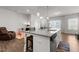 Kitchen island with bar seating, stainless steel appliances, and modern pendant lighting at 1805 Kauri Cliffs Dr, Fuquay Varina, NC 27526