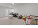 Spacious living room with carpet flooring, featuring lots of natural light and neutral tones at 1805 Kauri Cliffs Dr, Fuquay Varina, NC 27526