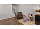 Spacious playroom with a comfortable recliner, play kitchen, and a cozy rug at 1805 Kauri Cliffs Dr, Fuquay Varina, NC 27526