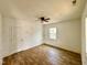 Bright bedroom with neutral walls, ceiling fan, wood-look flooring, and a large window at 216 S Tillery St, Rocky Mount, NC 27804