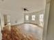 Spacious living room featuring wood-look floors and natural light through large windows at 216 S Tillery St, Rocky Mount, NC 27804