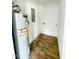 Utility room with new water heater, electrical panel, and wood-look flooring at 216 S Tillery St, Rocky Mount, NC 27804