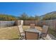 Private backyard with a patio, outdoor seating, and a well-maintained lawn at 2216 Tanners Mill Dr, Durham, NC 27703