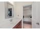 Bathroom with a vanity and view into an adjacent bedroom with a made bed at 2216 Tanners Mill Dr, Durham, NC 27703