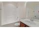Bright bathroom with a shower-tub combo, single vanity, and white tiled walls at 2216 Tanners Mill Dr, Durham, NC 27703