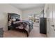 Bedroom showcases a black bed frame with an ornamental headboard and a window view at 2216 Tanners Mill Dr, Durham, NC 27703